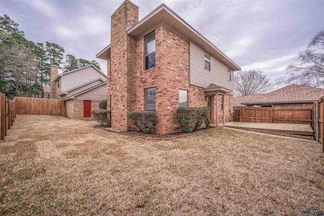 rear view of property featuring a lawn