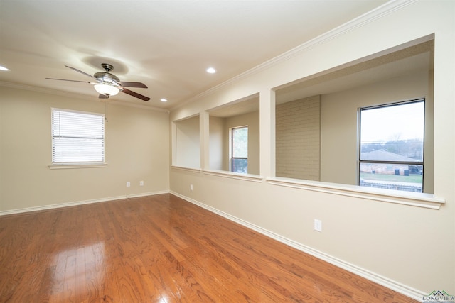 empty room featuring ceiling fan, ornamental molding, and wood-type flooring