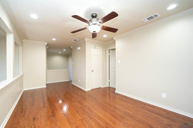 empty room featuring hardwood / wood-style floors, ornamental molding, and ceiling fan