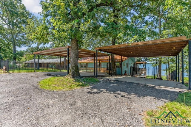 263 Crestwood Loop, Avinger, TX 75630 - view of parking featuring a carport and driveway
