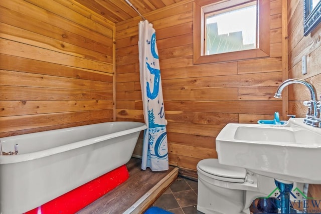 263 Crestwood Loop, Avinger, TX 75630 - bathroom with wooden walls, a freestanding bath, tile patterned floors, and wooden ceiling