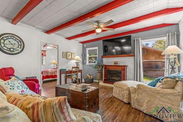 263 Crestwood Loop, Avinger, TX 75630 - living area featuring ceiling fan, wood finished floors, beamed ceiling, and a fireplace with raised hearth