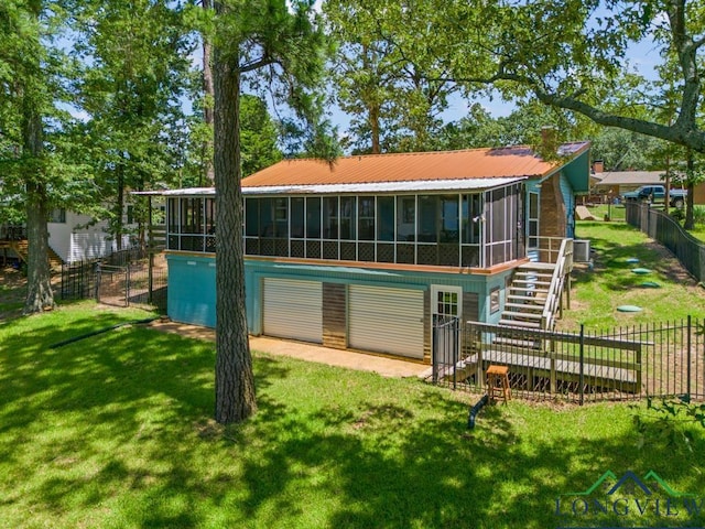 263 Crestwood Loop, Avinger, TX 75630 - back of house featuring a sunroom, stairs, a garage, and a chimney