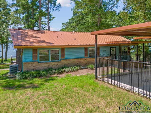 263 Crestwood Loop, Avinger, TX 75630 - view of front facade featuring brick siding, a metal roof, and an attached garage