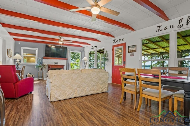 263 Crestwood Loop, Avinger, TX 75630 - living room featuring ceiling fan, beamed ceiling, wood finished floors, and a fireplace