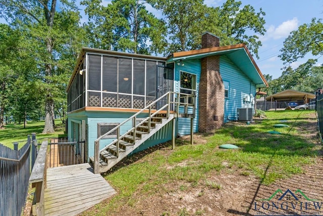 263 Crestwood Loop, Avinger, TX 75630 - back of house featuring a sunroom, a chimney, stairway, and a wooden deck