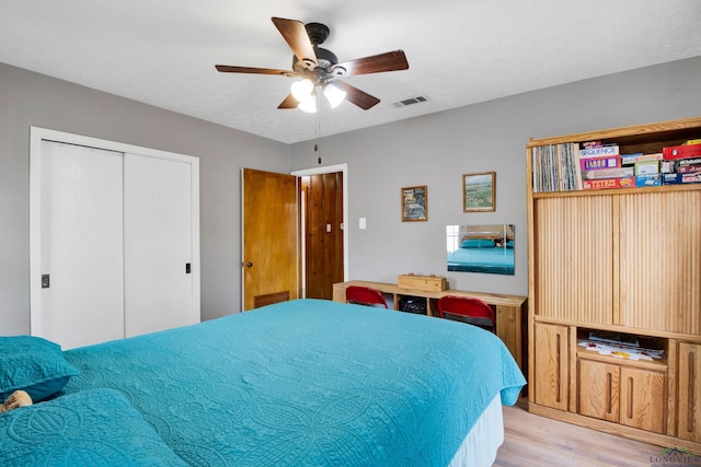 bedroom featuring a closet, ceiling fan, and light wood-type flooring