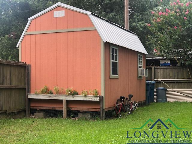 view of outbuilding featuring a lawn and cooling unit