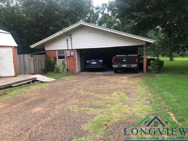 garage featuring a yard and a carport