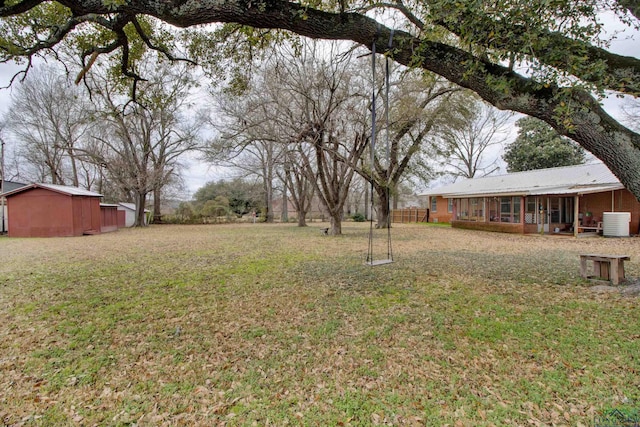 view of yard with a sunroom and central air condition unit