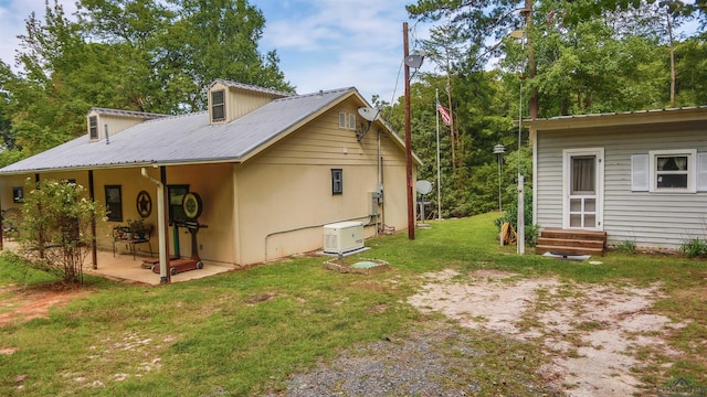 rear view of property featuring a yard