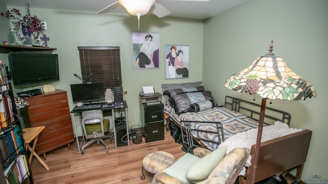 bedroom with ceiling fan and hardwood / wood-style flooring