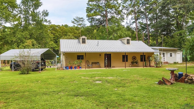 back of house with a yard and a carport