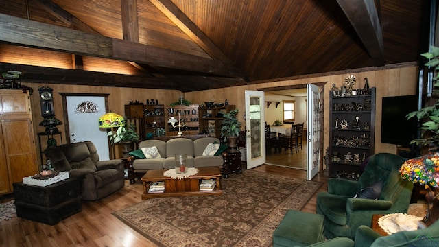 living room featuring hardwood / wood-style floors, wood walls, french doors, beam ceiling, and wood ceiling