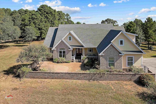 view of front of home with a front yard and a porch