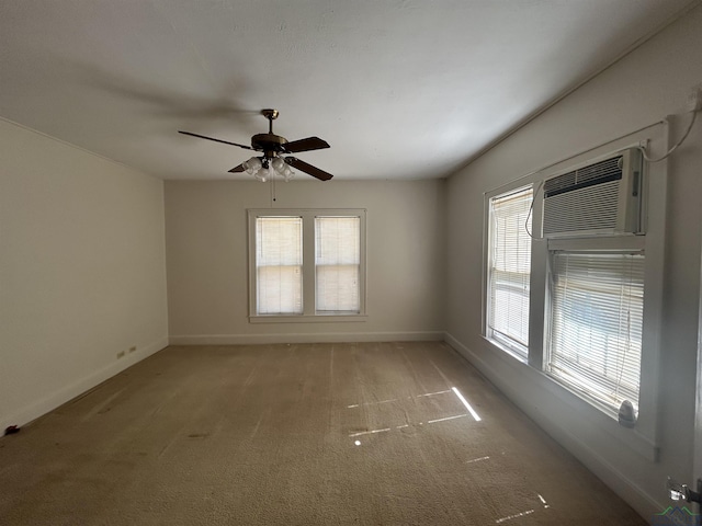 spare room with light carpet, plenty of natural light, baseboards, and a ceiling fan