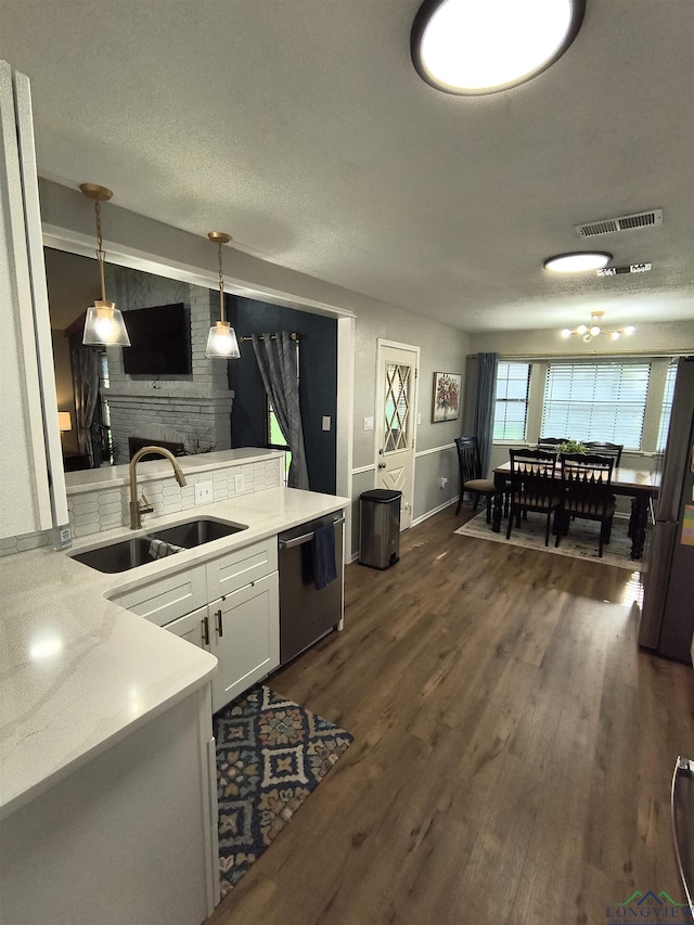 1101 N Idlewood Dr, White Oak, TX 75693 - kitchen with a sink, stainless steel appliances, white cabinetry, light countertops, and dark wood-style flooring