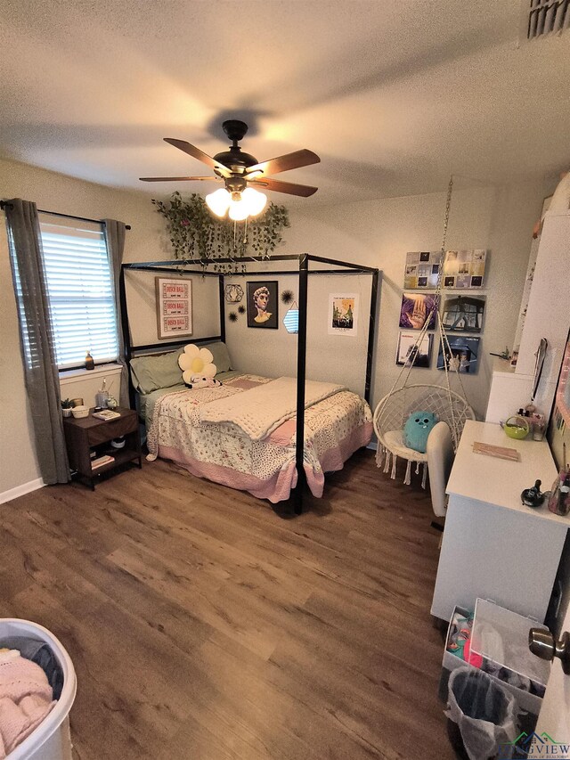 1101 N Idlewood Dr, White Oak, TX 75693 - bedroom featuring wood finished floors, ceiling fan, and a textured ceiling