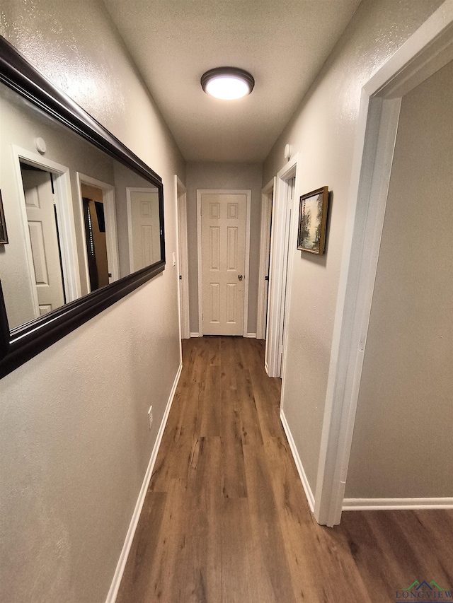 1101 N Idlewood Dr, White Oak, TX 75693 - hallway with wood finished floors and baseboards
