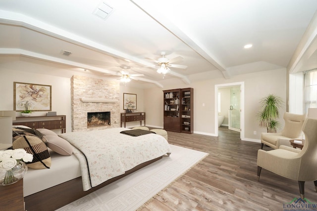 813 Kenwood Ln, Longview, TX 75604 - bedroom with baseboards, wood finished floors, beam ceiling, a stone fireplace, and recessed lighting