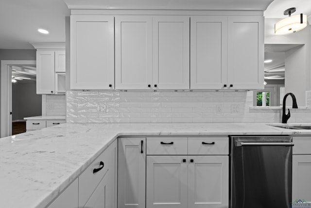 813 Kenwood Ln, Longview, TX 75604 - kitchen featuring dishwasher, a sink, white cabinets, backsplash, and light stone countertops