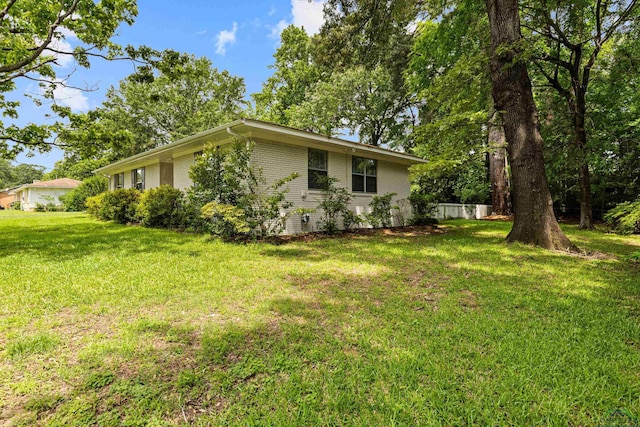 813 Kenwood Ln, Longview, TX 75604 - view of home's exterior featuring a lawn and brick siding