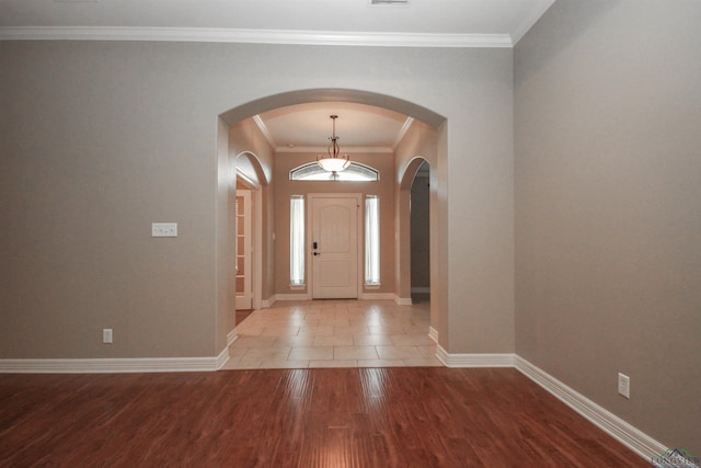 entrance foyer featuring hardwood / wood-style floors and crown molding