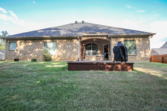 back of property featuring a lawn