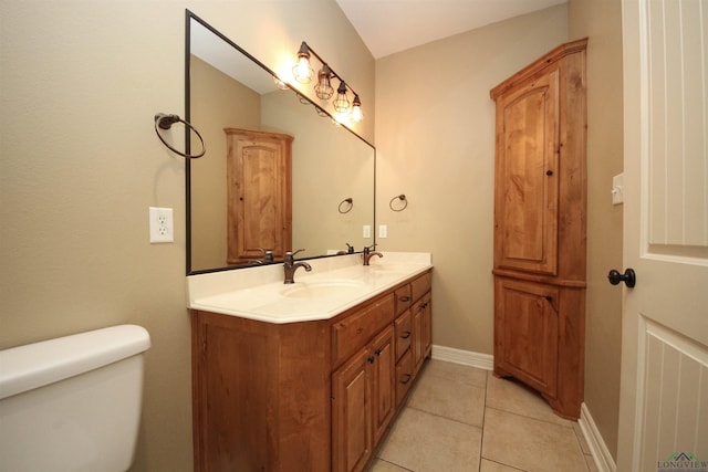 bathroom featuring tile patterned floors, vanity, and toilet