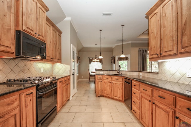 kitchen featuring sink, dark stone counters, pendant lighting, black appliances, and ornamental molding