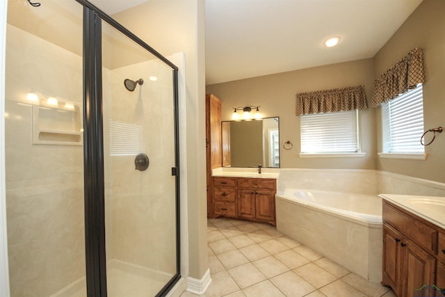 bathroom with plus walk in shower, vanity, and tile patterned floors