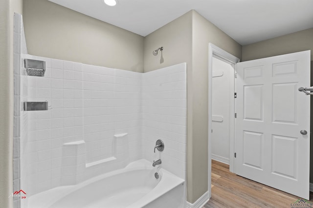 bathroom featuring hardwood / wood-style floors and shower / washtub combination