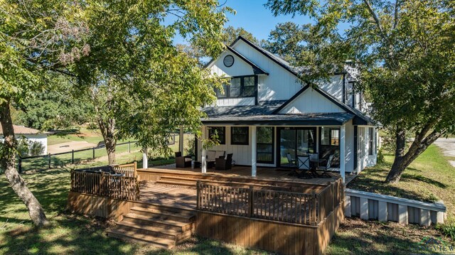 rear view of property featuring outdoor lounge area and a deck