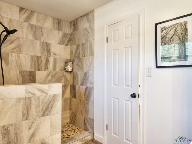 bathroom with tiled shower