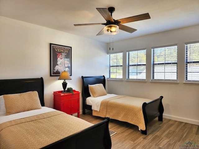 bedroom featuring ceiling fan and hardwood / wood-style flooring