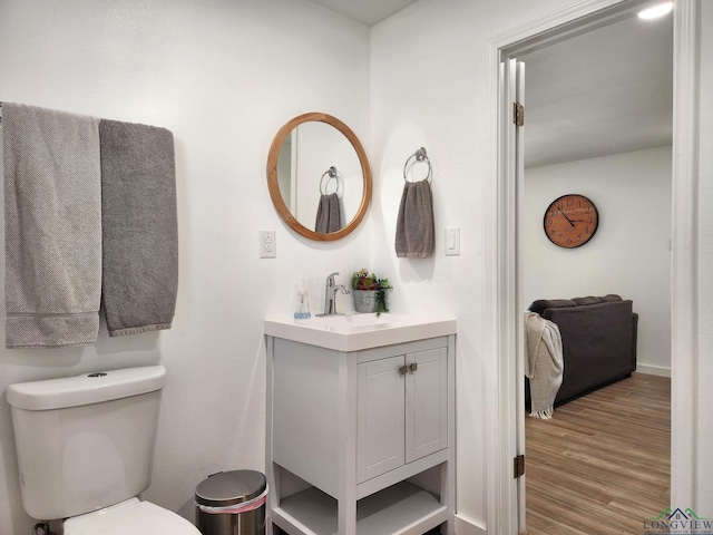 bathroom featuring hardwood / wood-style floors, vanity, and toilet