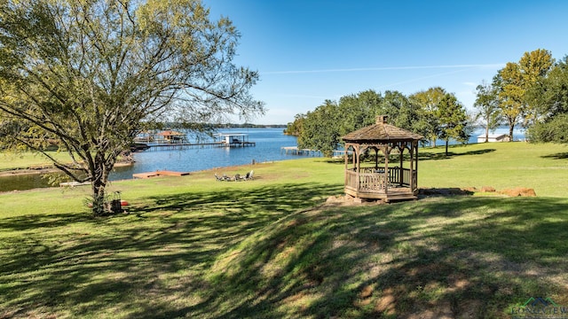 view of yard featuring a gazebo and a water view