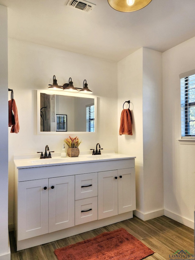 bathroom with vanity and hardwood / wood-style flooring