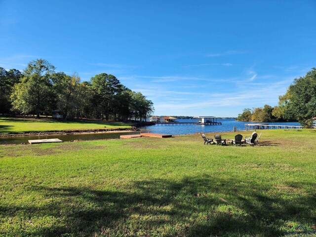 surrounding community featuring a water view and a yard
