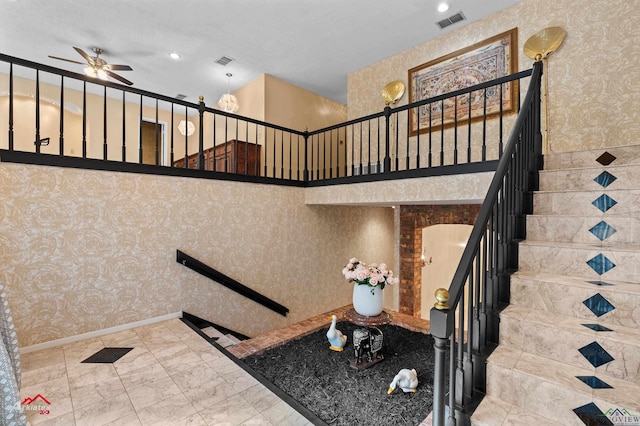 1502 Meandering Way, Longview, TX 75604 - staircase featuring a ceiling fan, wallpapered walls, a towering ceiling, and recessed lighting