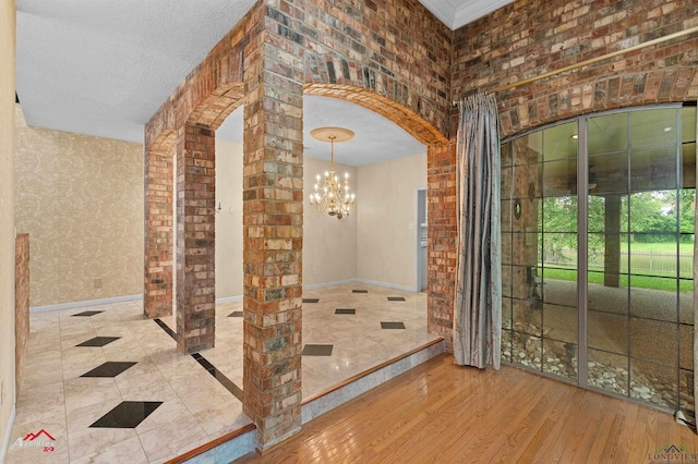 1502 Meandering Way, Longview, TX 75604 - wine cellar featuring arched walkways, a chandelier, wood finished floors, and baseboards