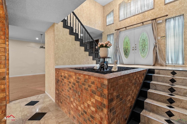 1502 Meandering Way, Longview, TX 75604 - tiled entryway featuring a ceiling fan, stairs, and baseboards