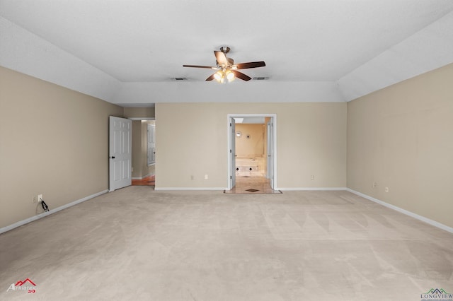 1502 Meandering Way, Longview, TX 75604 - unfurnished bedroom with light carpet, baseboards, connected bathroom, and vaulted ceiling
