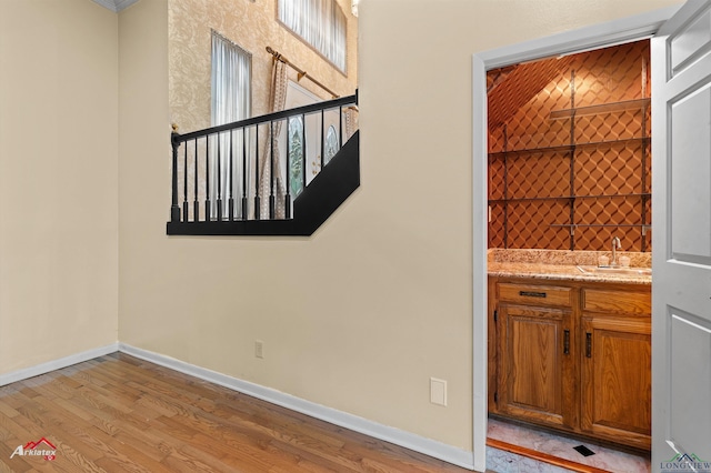 1502 Meandering Way, Longview, TX 75604 - unfurnished room with baseboards, wood finished floors, and wet bar