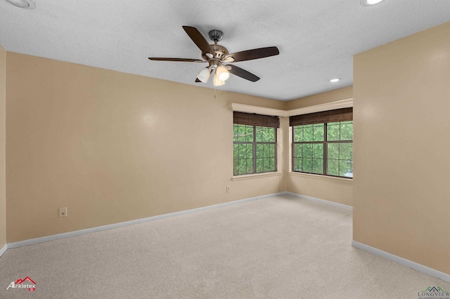 1502 Meandering Way, Longview, TX 75604 - empty room with carpet flooring, ceiling fan, baseboards, recessed lighting, and a textured ceiling