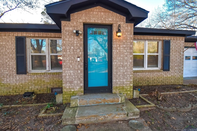 view of exterior entry featuring a garage