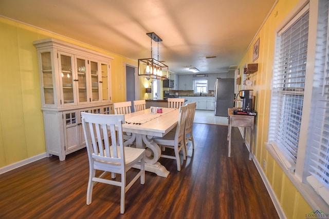 dining room featuring dark hardwood / wood-style floors and a notable chandelier