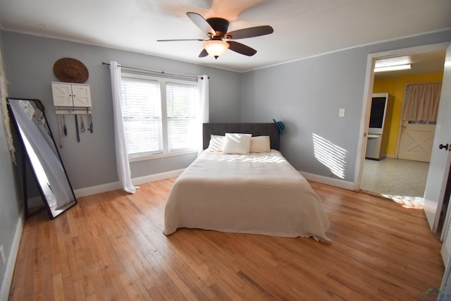 bedroom with ceiling fan and light hardwood / wood-style flooring