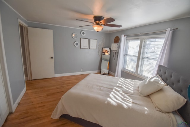 bedroom with hardwood / wood-style flooring and ceiling fan