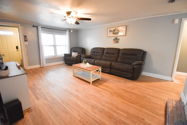 living room featuring crown molding, ceiling fan, and light wood-type flooring